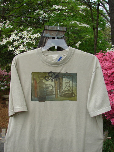 2000 NWT Short Sleeved Tee Chem Class Dove Size 1 displayed on a hanger, featuring a colorful chemistry class theme painting and a thicker ribbed neckline, from Bluefishfinder.com's vintage collection.