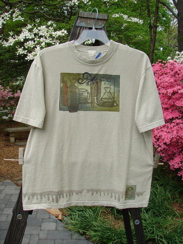 2000 NWT Short Sleeved Tee Chem Class Dove Size 1 displayed on a hanger, featuring a colorful chemistry-themed painting on medium-weight organic cotton, with a thicker ribbed neckline and straight shape.