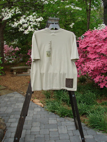 2000 NWT Short Sleeved Tee Chem Class Dove Size 1 displayed on a rack, showcasing a thicker ribbed neckline, straight shape, and a colorful chemistry class theme with a signature Blue Fish patch.