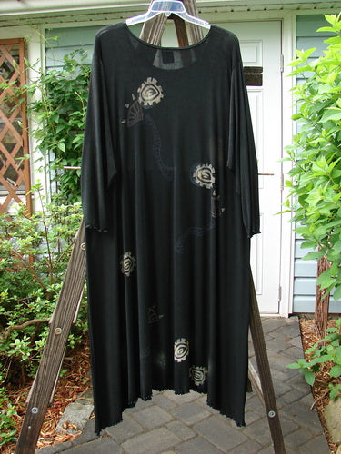 1995 Acetate Lycra Celebration Dress Celtic Turn Onyx Size 2 on a swing, featuring a flowing, lettuce-edged hemline, rounded neckline, and distinctive Celtic pattern.