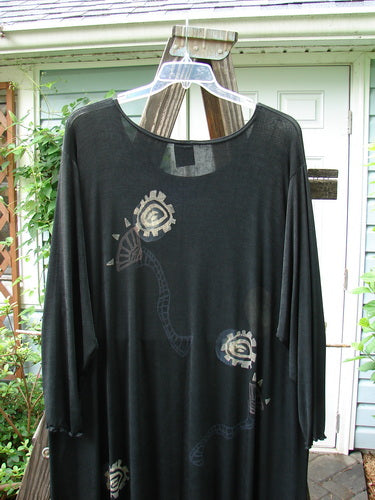 1995 Acetate Lycra Celebration Dress with Celtic Turn design, size 2. A black shirt on a swinger from a clothes rack.