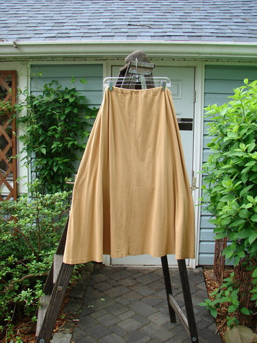 1994 Scoop Pocket Skirt Hot Pepper Dijon Size 1: A skirt with a drawstring waist, painted pockets, and sectional panels on a rack.