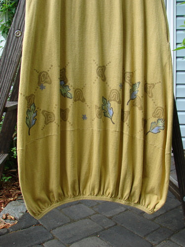 A yellow blanket on a ladder, a yellow towel with leaves on it, and a close-up of a stone surface and path. 2000 Cotton Hemp Libby Jumper Fall Leaf Gold Size 1.