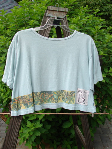 1992 Short Sleeved Crop Tee with butterfly and daisy pattern on a swinger
