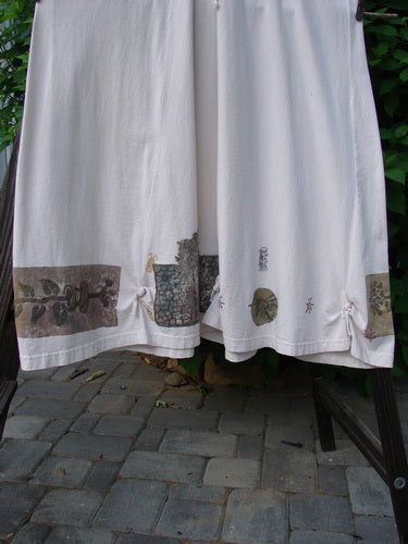 A white towel on a rack, part of the 1994 Loop Dress Magic Garden Tea Dye Smaller OSFA collection.