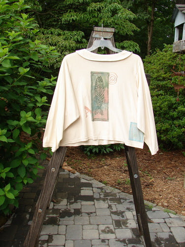 1994 Box Pocket Jacket Mixed Letter A Ecru Size 2 on a wooden stand, featuring unique collar, painted front pockets, vintage buttons, and Blue Fish patch.