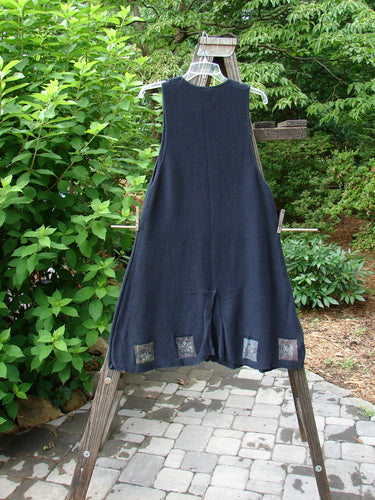 1994 Vent Vest Sweater Jumper Sea Life Black OSFA displayed on a rack, showcasing its whimsical detailed hemline and slenderizing A-line shape with three clay buttons.