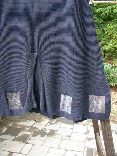 Close-up of the 1994 Vent Vest Sweater Jumper Sea Life Black OSFA, highlighting detailed clay buttons and whimsical hemline patterns, showcasing its unique knitted texture and slenderizing A-line shape.