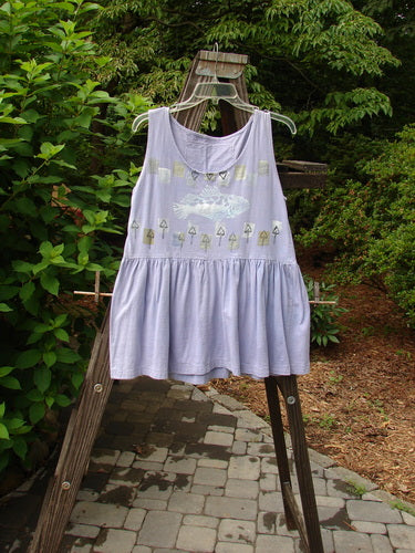 A purple dress with a fish theme on a wooden ladder. 

Description: 1990 Tiny Tier Top Fish Clover Tiny OSFA. This vintage dress features a smaller shape, arm openings, and a deep rounded neckline. The dress has a super bottom flounce and a signature Blue Fish patch on the upper rear back. It is made from cotton and is in perfect condition. The dress is just as cute as can be for a tiny adult. The measurements are as follows: Bust 36, Waist 36, Hips 40, and Length 28 inches.