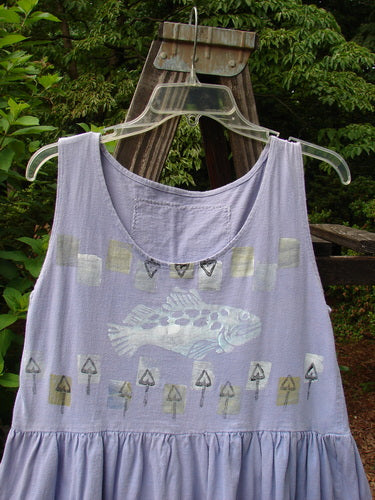 1990 Tiny Tier Top Fish Clover Tiny OSFA: A purple tank top with a fish on it. Smaller shape, arm openings, deep rounded neckline, and super bottom flounce. Perfect for a tiny adult.