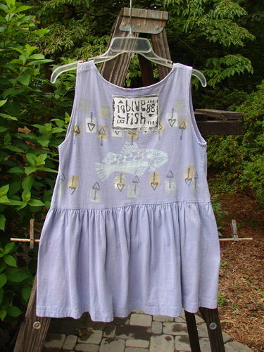 "1990 Tiny Tier Top Fish Clover Tiny OSFA: A purple dress with a fish theme, featuring a deep rounded neckline, arm openings, and a super bottom flounce. Perfect for a Tiny Adult. Vintage Blue Fish Clothing from the Summer Collection of 1990."