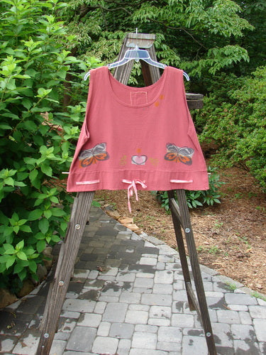 1992 Camisette Top Butterfly Sienna OSFA displayed on a wooden ladder, featuring a scooped neckline, swingy hemline with button holes, butterfly and heart theme paint, and a Blue Fish patch.
