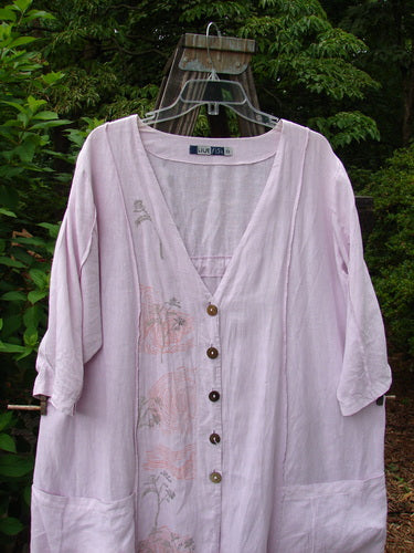 Barclay Linen Double Tie Back Jacket Sprig Pink Cloud Size 0 displayed on a hanger, showcasing its deep V-neckline, varying hemline, and exterior vertical stitchery.