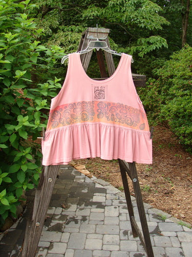 1992 Peplum Top Rose Border Pink Clover OSFA displayed on a wooden rack, showcasing its baby doll style, wide waist, and signature vintage details like the Blue Fish patch and gathered bottom flounce.