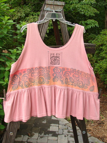 1992 Peplum Top Rose Border Pink Clover OSFA displayed on a hanger, featuring a downward yoked waist seam, rounded neckline, higher armholes, and a flounced bottom with vintage rose pattern.