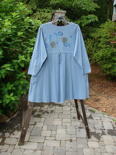 1997 Mask Jacket Windy Floral Peacock Size 1 displayed on a swing hanger, highlighting its bell shape, two-button closure, deep side pockets, and rounded hemline in mid-weight cotton.