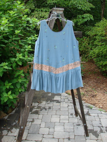 1990 Button Tier Top Tiny Vase Ocean Blue OSFA displayed on a clothes rack showcasing its intricate gathered flounce and unique hemline.