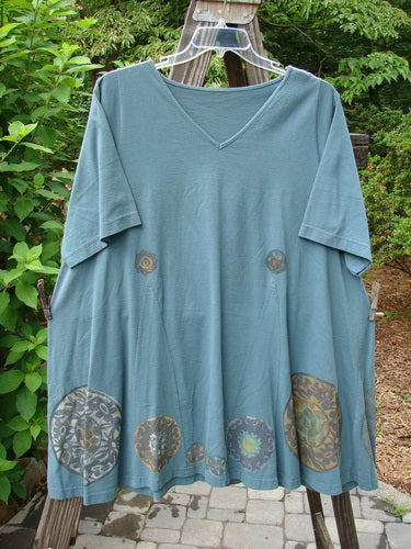 1993 Vagabond Dress Metallic Pinwheel Grey Green OSFA featuring a V-shaped neckline, A-line shape, and unique pinwheel design. Made from medium-weight cotton with a vintage-inspired sweeping lower hem.