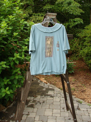 A 1994 Compass Top Chair Dusk Size 1, a blue shirt with a picture on it, from the Transitions Collection. Features include a big pointed over collar and original BF buttons.