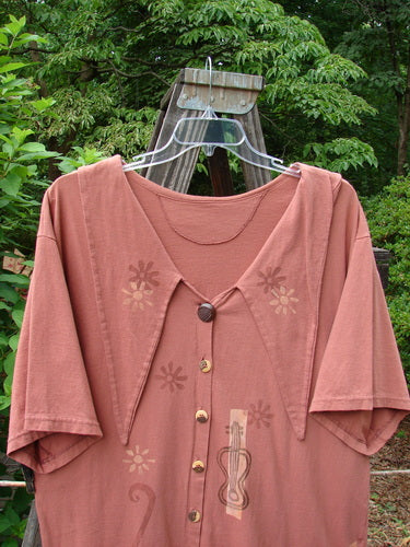 1994 Compass Top Mixed Terra Size 2 displayed on a hanger, featuring an exaggerated elongated collar, original vintage buttons, side vents, and garden creature theme paint, from Bluefishfinder's vintage collection.