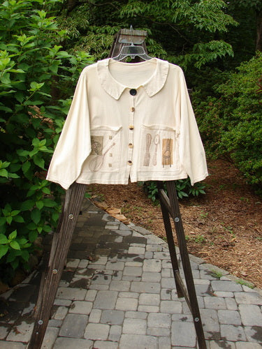 1994 Box Pocket Jacket Kitchen Tool Ecru Size 1 on a rack, featuring a full unique collar, large painted pockets, vintage buttons, and a cropped boxy shape.