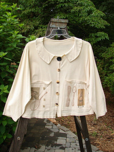 1994 Box Pocket Jacket Kitchen Tool Ecru Size 1, featuring a unique full collar, large painted front pockets, vintage buttons, cropped boxy shape, and signature Blue Fish patch, displayed on a metal rack.