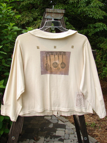 1994 Box Pocket Jacket Kitchen Tool Ecru Size 1: White jacket with large painted pockets, oversized buttons, and a unique collar, featuring vintage kitchen-themed designs and a signature Blue Fish patch.