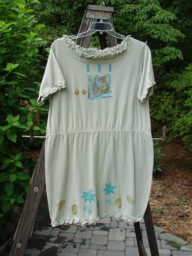 1991 Short Milkmaid Dress Sun Star Sage OSFA on a rack, showcasing its unique bell shape, laced neck and sleeve lines, and distinct star and veggie theme paint.