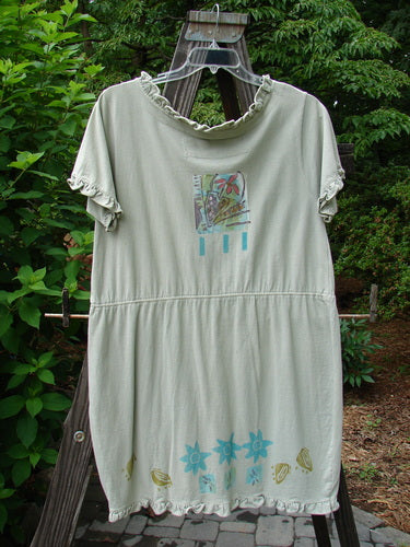 1991 Short Milkmaid Dress Sun Star Sage OSFA: A white dress with a graphic design on it. Features a unique bell-shaped dropped waistband and a laced neck hem and sleeve line.