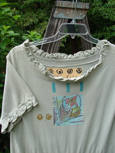 1991 Short Milkmaid Dress Sun Star Sage OSFA displayed on a hanger against an outdoor backdrop, showcasing the unique bell shape, laced neckline, and classic 1991 star and veggie theme.