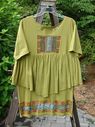 1993 NWT Picnic Dress Structural Olive OSFA features a gently rounded V-shaped neckline, a continuous flounce, and a fall-themed paint border. Mid-weight cotton, vintage signature patch, one size fits all.