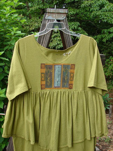 1993 NWT Picnic Dress in Olive OSFA, featuring a gently rounded V neckline, continuous flounce, fall theme border, and vintage signature patch. Perfect for expressing individuality with mid-weight cotton.