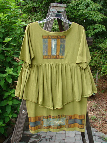 1993 NWT Picnic Dress Structural Olive OSFA displayed on a swing, featuring a gently rounded V-shaped neckline, flounce details, and vintage signature patch from the BlueFishFinder Summer Collection.