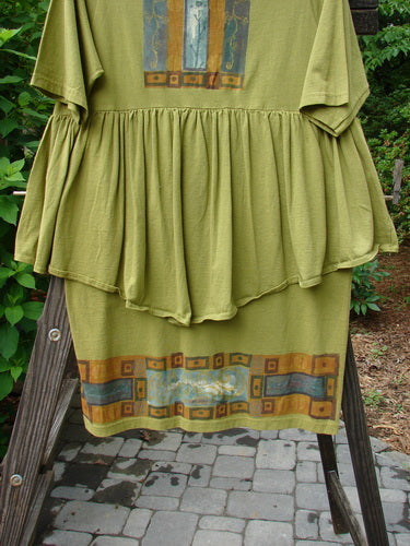 1993 NWT Picnic Dress Structural Olive OSFA displayed on a wooden stand, showcasing a gently rounded V neckline, flouncy hem, and vintage signature patch, emphasizing its unique, vintage charm.