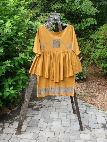 A 1993 Picnic Dress titled Windy Berries Oro OSFA featuring a gently rounded V neckline, flouncy hem, and earth and berry theme, displayed on a clothes rack.
