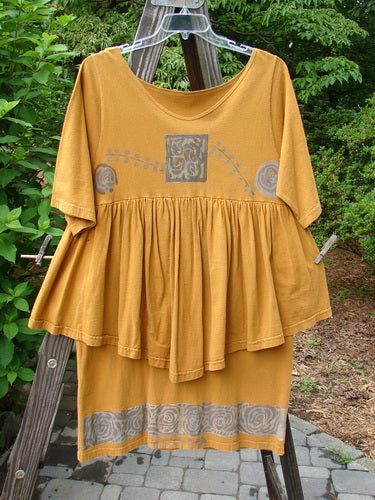 1993 Picnic Dress Windy Berries Oro OSFA displayed on a wooden ladder, featuring a gently rounded V neckline, flirty flounce, and vibrant Earth and Berry theme pattern.