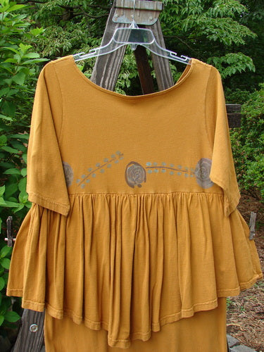 1993 Picnic Dress Windy Berries Oro OSFA displayed on a hanger, featuring a floral design, rounded V neckline, and straight upper waist seam with a pencil straight shorter under piece.