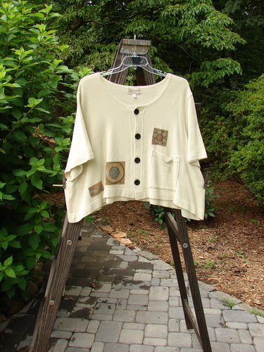 2000 Patched Recycle Jacket Science Natural Size 2 displayed on a hanger, featuring a feminine rounded neckline, flared hemline, colorful patches, and dark recycled buttons from Bluefishfinder's vintage collection.