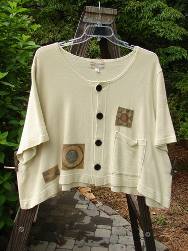 2000 Patched Recycle Jacket Science Natural Size 2: White jacket with black buttons, rounded neckline, flared hemline, front pocket, and colorful bio-themed patches.