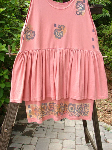 1992 Peplum Dress Floral Border Pink Clover OSFA hanging on a rack, featuring vintage buttons, gathered lower, empire waist, and floral border design, part of Bluefishfinder's vintage collection.