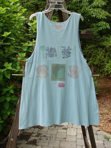 1994 Tuesday's Dress Multi Theme Ice Small Size 1 hanging on a clothesline, showcasing a downward curved slight empire waistline with three buttons and a Blue Fish stamp on the back.