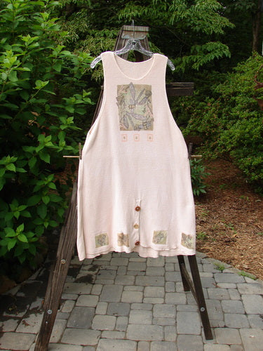 1994 Vent Vest Sweater Jumper Dragonfly Tea Dye Smaller OSFA: A dress on a swinger with a white apron featuring a patchwork design. Close-ups of a drawing and a stone floor.