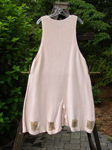 1994 Vent Vest Sweater Jumper Dragonfly Tea Dye Smaller OSFA on a clothes rack, showcasing its detailed hemline and three clay buttons with unique designs.