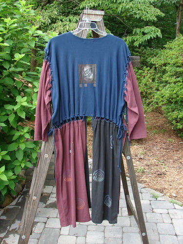 1997 Strapwork Jacket Vest Celtic Spin Window Pane OSFA: Blue and pink shirt on a wooden rack, close-up of cloth, snail on a wooden post, long pants on a ladder, close-up of a plant.
