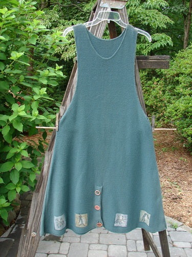 1994 Vent Vest Sweater Jumper Mixed Theme Lichen OSFA: A blue dress on a clothes rack, featuring a slenderizing A-line shape, detailed hemline whimsical paint, and a rear walking vent.