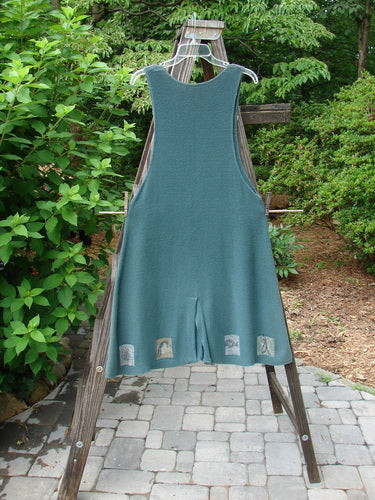 1994 Vent Vest Sweater Jumper Mixed Theme Lichen OSFA displayed on a swinging hanger, highlighting its collectible design with clay buttons and a whimsical hemline.