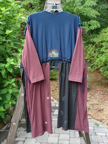 1997 Strapwork Jacket Vest Swirl City Multi OSFA displayed on a clothes rack, highlighting its unique design with removable sleeves and detailed stamped clay buttons.