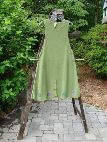 1994 Vent Vest Sweater Jumper Stars Kelp Smaller OSFA: A green dress on a clothes rack, featuring a slenderizing A-line shape, detailed hemline, and whimsical star paint.