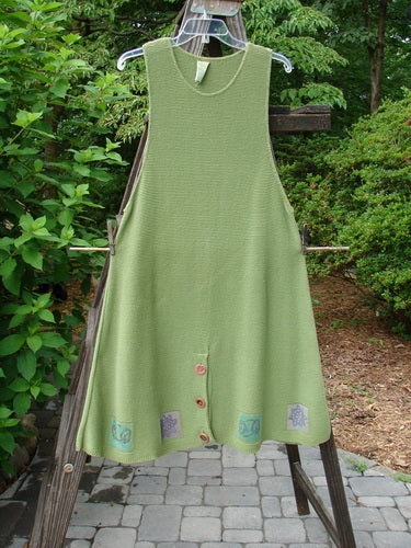 1994 Vent Vest Sweater Jumper Stars Kelp Smaller OSFA, green knitted vest with 3 unique clay buttons, A-line shape, detailed hemline, displayed hanging on a clothesline.