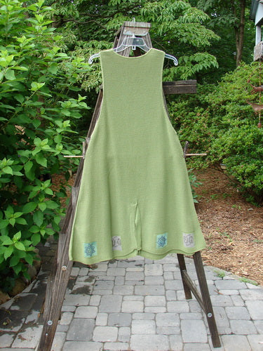 1994 Vent Vest Sweater Jumper Stars Kelp Smaller OSFA displayed on a rack, featuring detailed hemline, clay buttons, and a slenderizing A-line shape.